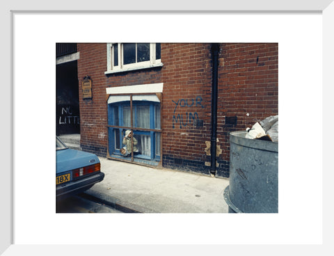 Two children looking out of a window 1986