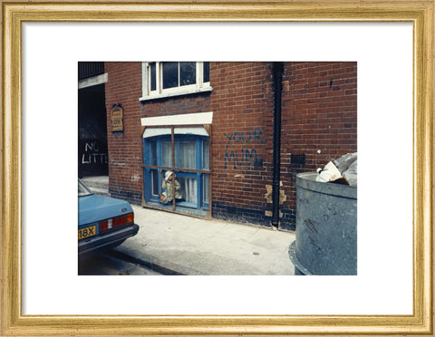 Two children looking out of a window 1986