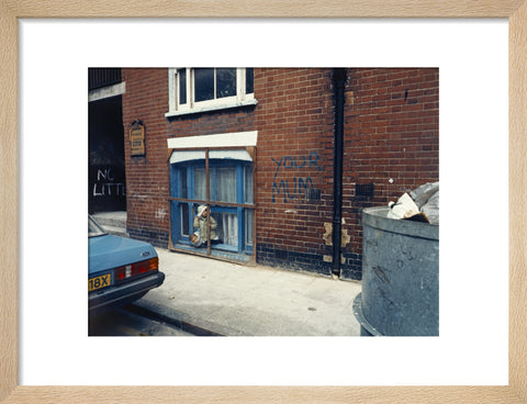 Two children looking out of a window 1986