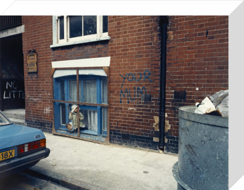 Two children looking out of a window 1986