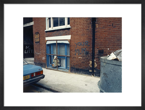 Two children looking out of a window 1986