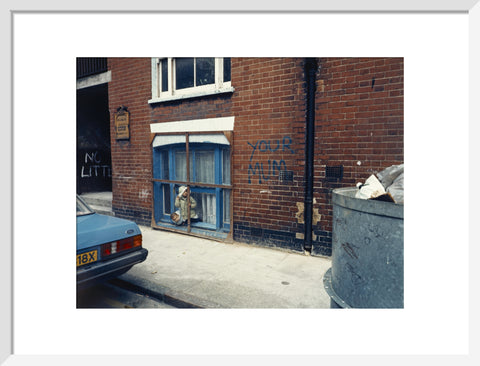 Two children looking out of a window 1986