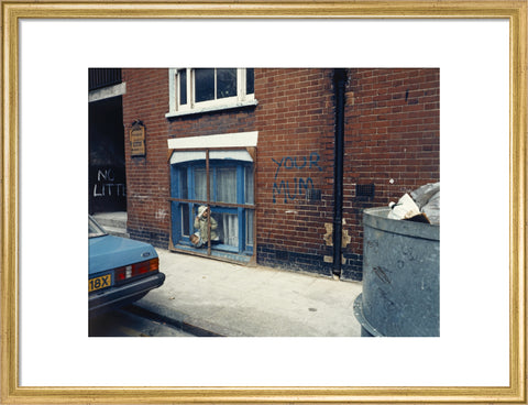 Two children looking out of a window 1986