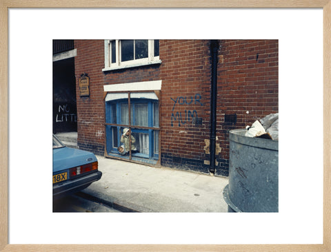 Two children looking out of a window 1986