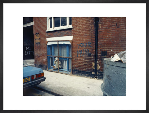 Two children looking out of a window 1986