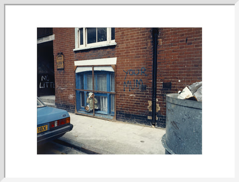 Two children looking out of a window 1986