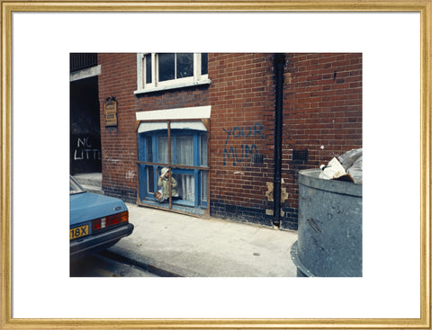 Two children looking out of a window 1986