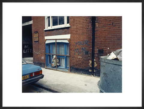 Two children looking out of a window 1986