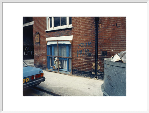 Two children looking out of a window 1986