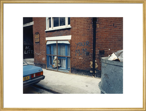 Two children looking out of a window 1986