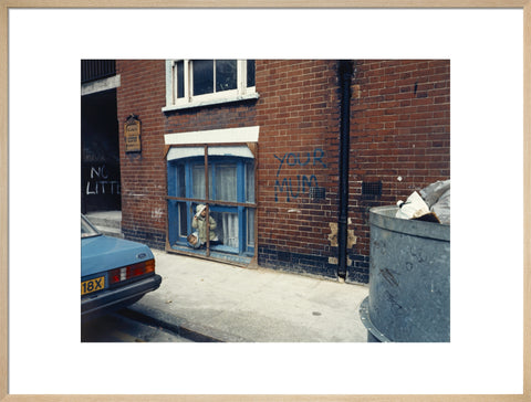 Two children looking out of a window 1986