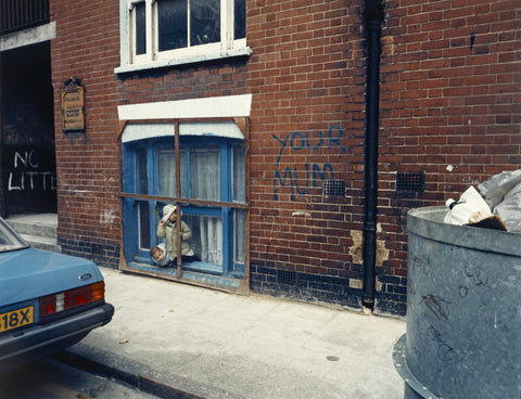 Two children looking out of a window 1986