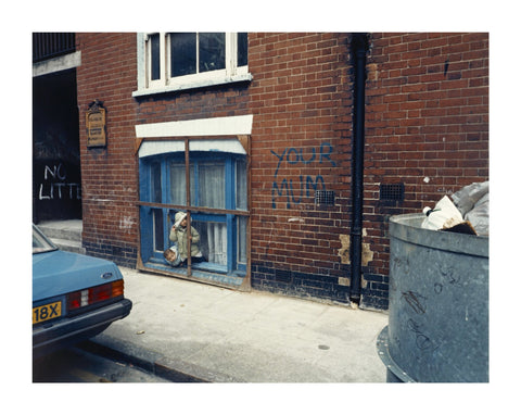 Two children looking out of a window 1986
