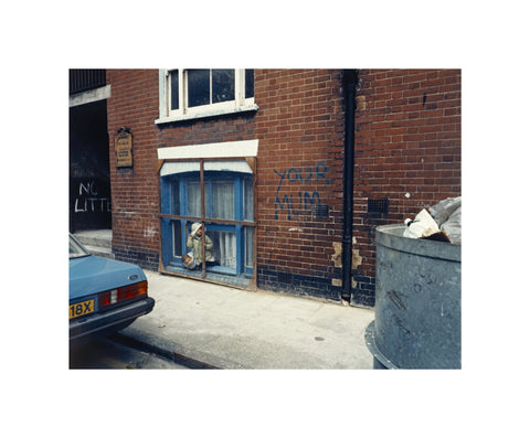 Two children looking out of a window 1986