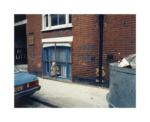 Two children looking out of a window 1986