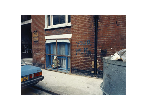 Two children looking out of a window 1986