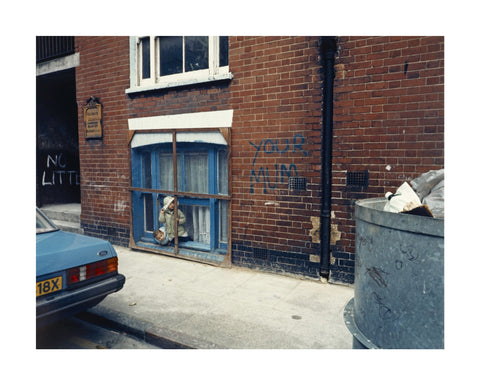 Two children looking out of a window 1986