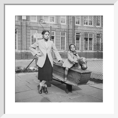 East London Afro-Caribbean child and mother in playground 1952