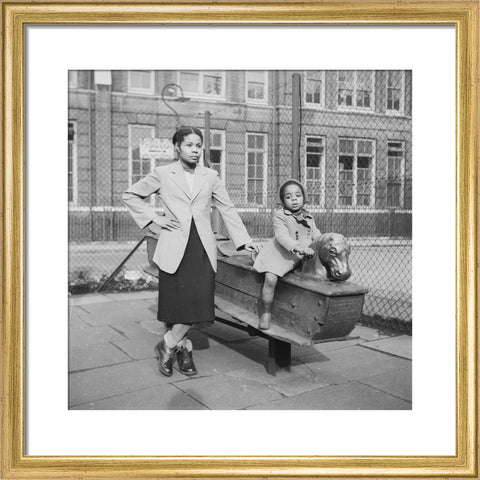 East London Afro-Caribbean child and mother in playground 1952