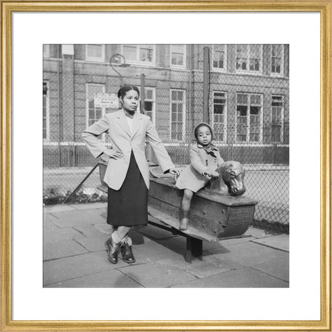 East London Afro-Caribbean child and mother in playground 1952