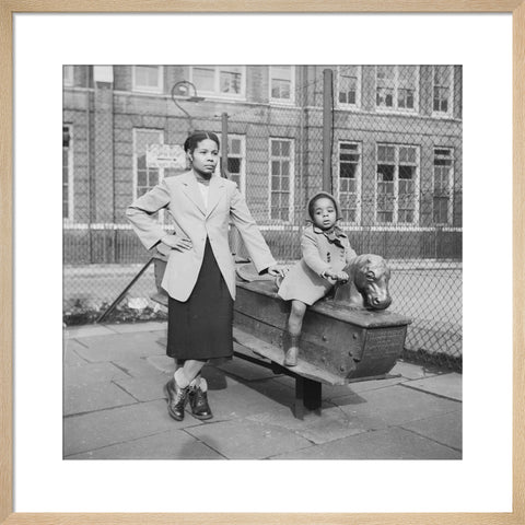 East London Afro-Caribbean child and mother in playground 1952