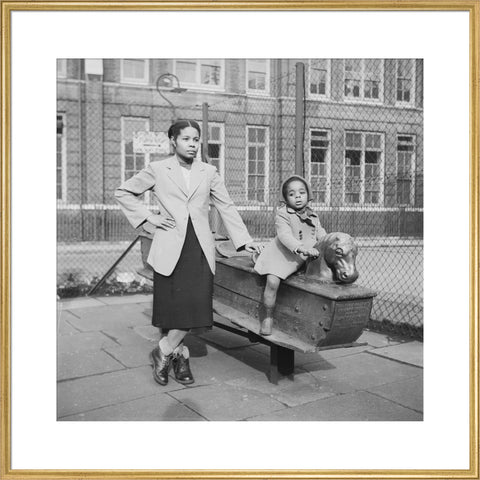 East London Afro-Caribbean child and mother in playground 1952
