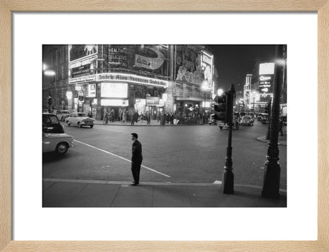 Lone man in Piccadilly at night 1960