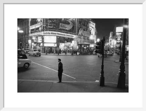 Lone man in Piccadilly at night 1960