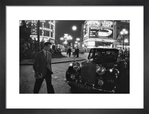 A man cuts across traffic at Piccadilly Circus 1960