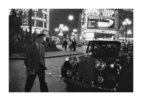 A man cuts across traffic at Piccadilly Circus 1960