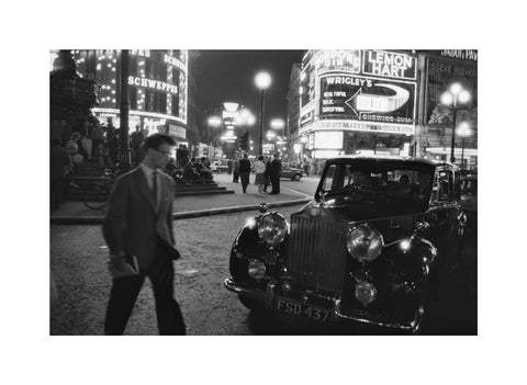 A man cuts across traffic at Piccadilly Circus 1960
