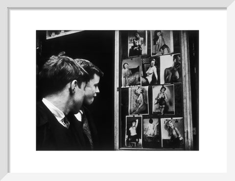 Two boys gazing at images of semi-nude women 1961