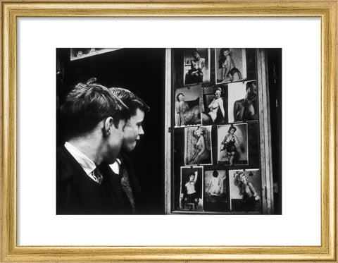 Two boys gazing at images of semi-nude women 1961