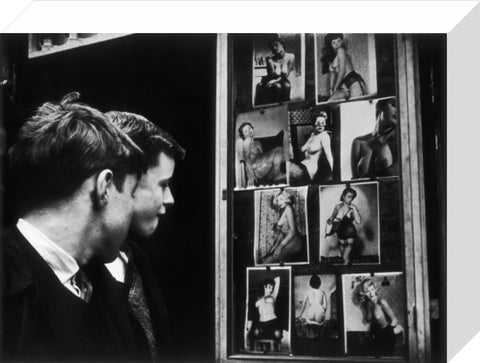 Two boys gazing at images of semi-nude women 1961