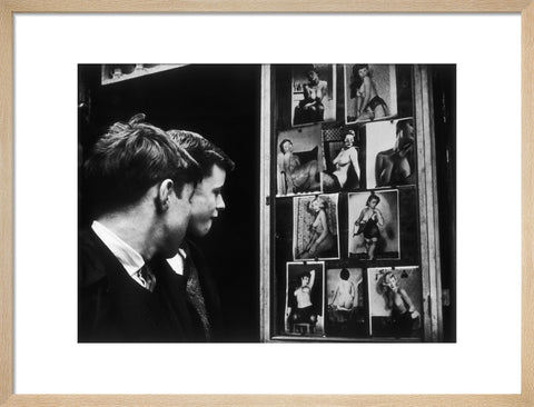 Two boys gazing at images of semi-nude women 1961