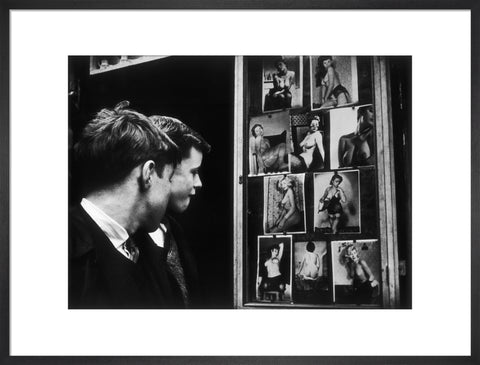 Two boys gazing at images of semi-nude women 1961