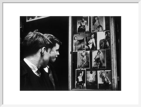 Two boys gazing at images of semi-nude women 1961
