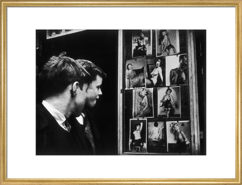 Two boys gazing at images of semi-nude women 1961
