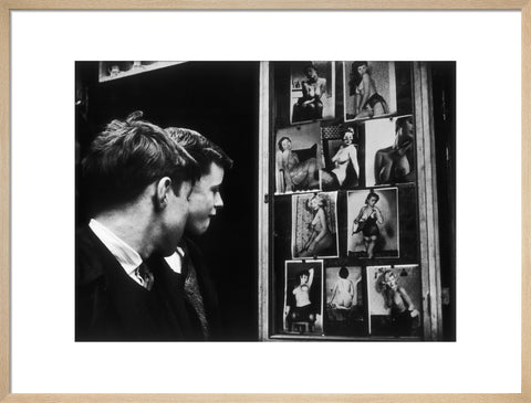 Two boys gazing at images of semi-nude women 1961