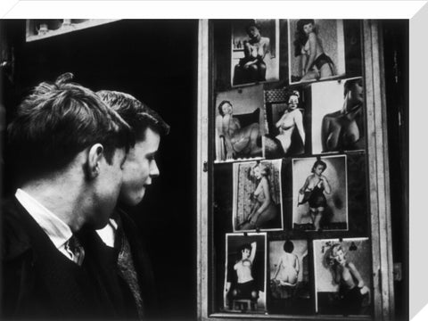 Two boys gazing at images of semi-nude women 1961