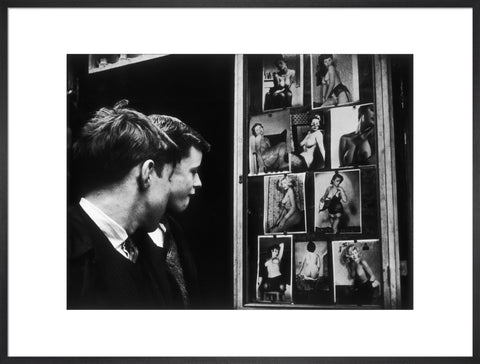 Two boys gazing at images of semi-nude women 1961