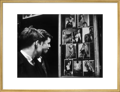 Two boys gazing at images of semi-nude women 1961