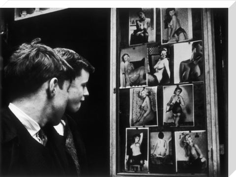 Two boys gazing at images of semi-nude women 1961