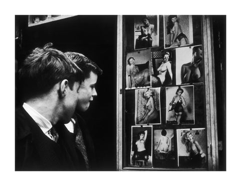 Two boys gazing at images of semi-nude women 1961