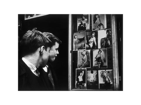 Two boys gazing at images of semi-nude women 1961