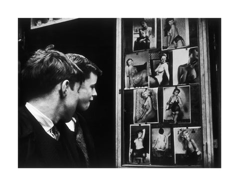 Two boys gazing at images of semi-nude women 1961