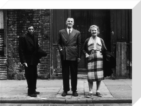 Three people stand on street facing the camera 1961