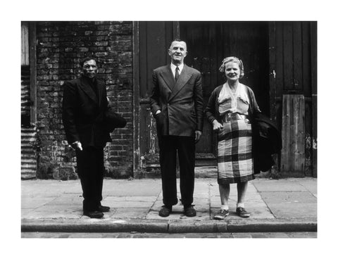 Three people stand on street facing the camera 1961