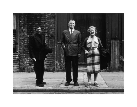 Three people stand on street facing the camera 1961