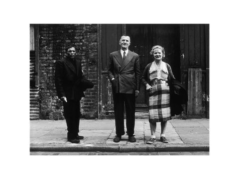 Three people stand on street facing the camera 1961